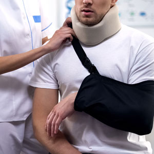 Injured man with arm sling and neck brace after car accident seeking legal help in Kentucky.