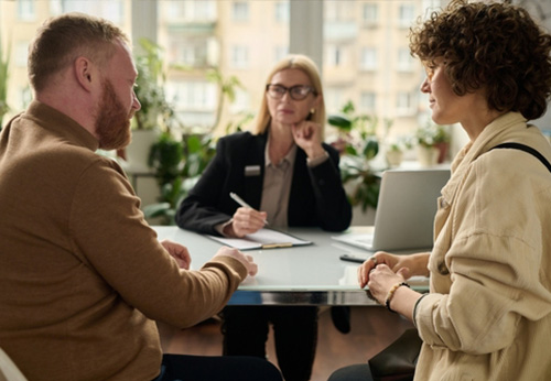 Attorney consulting with a male and female client about family law cases in Hardin County